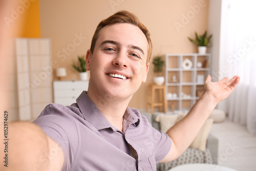 Young man taking selfie at ...