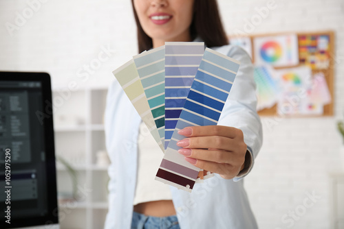 Female designer holding col...