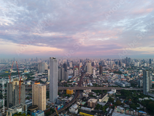 Bangkok aerial panoramic view from the Sukhumvit district at sunrise with beautiful purple cloudy sky. A large asian capital city with skyscrapers and millions of inhabitants photo