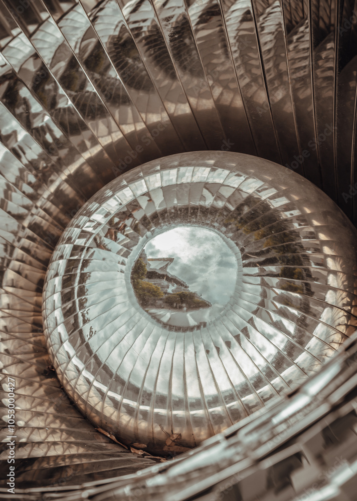 Close-up of Creative pupil shape sphere mirror ball. Stainless steel pupil shape sphere sculptures are unique, eye-catching art pieces, merging the simplicity of a s
