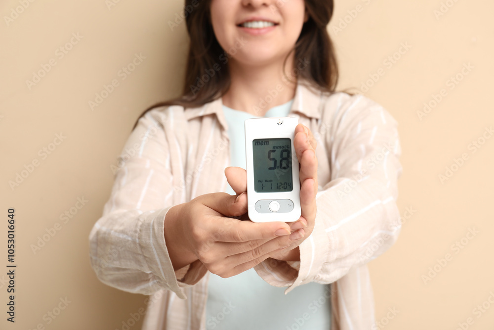 Diabetic young woman with glucometer on beige background, closeup Diabetic young woman with glucometer on beige background, closeup