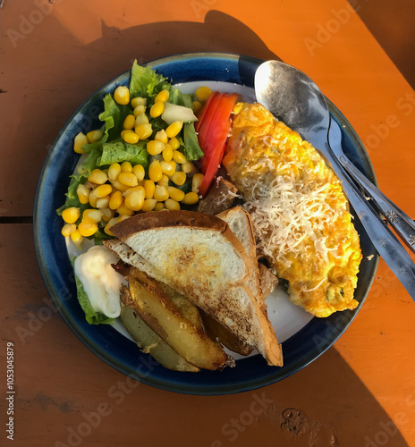 omelette with bread, potatoes and lettuce