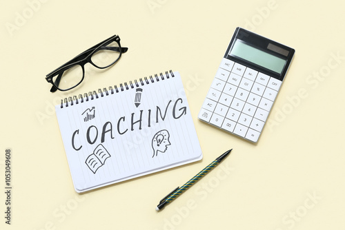 Wallpaper Mural Notebook with word COACHING, calculator and eyeglasses on beige background Torontodigital.ca