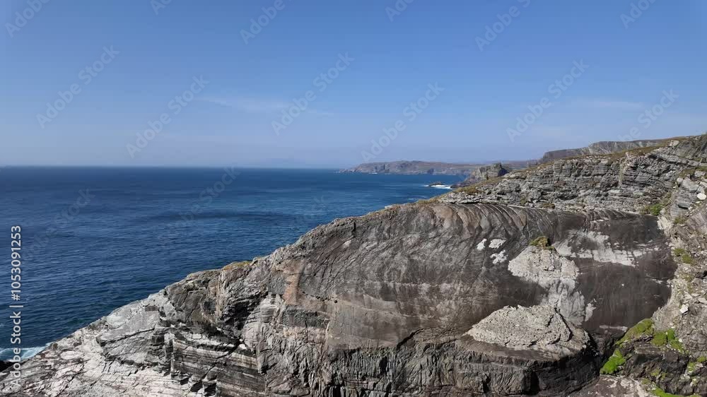 Atlantic ocean and waves crashing on cliffs on a sunny day in Ireland Atlantic ocean and waves crashing on cliffs on a sunny day in Ireland