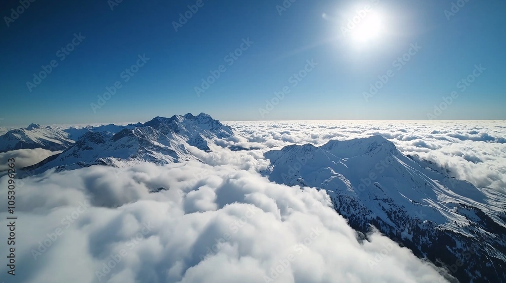 Fototapeta premium Snowy Mountain Peaks Above the Clouds: A breathtaking aerial view of snow-capped mountain peaks piercing through a vast sea of clouds, bathed in the golden glow of the sun.