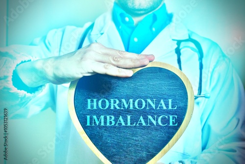 Doctor holding a heart with the inscription: HORMONAL IMBALANCE. Hormonal imbalance medicine and healthcare concept. Hormone disproportion. Woman hormonal imbalance. photo