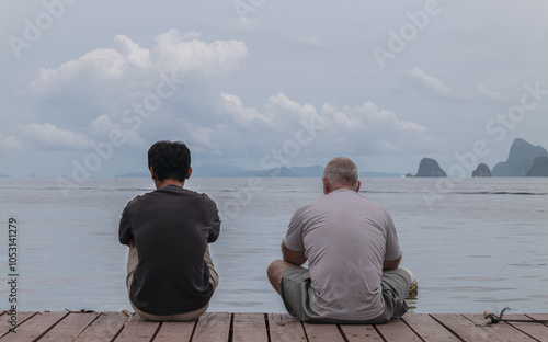 Rear view of people sitting against sea. Thailand photo