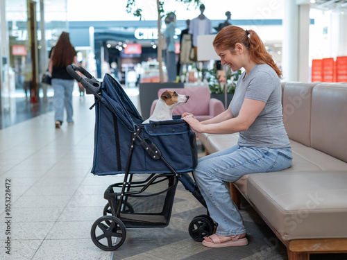 Caucasian woman petting her Jack Russell terrier dog. Shopping with a pet in the mall. photo