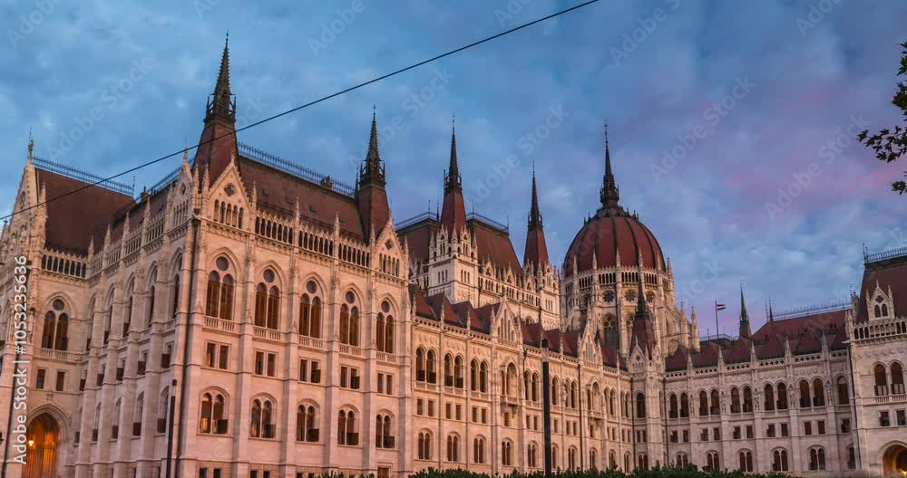 Budapest, Hungary - September 28, 2024: Morning Glow on the Iconic Hungarian Parliament. Timelapse, zoom out transition. Budapest, Hungary - September 28, 2024: Morning Glow on the Iconic Hungarian Parliament. Timelapse, zoom out transition.