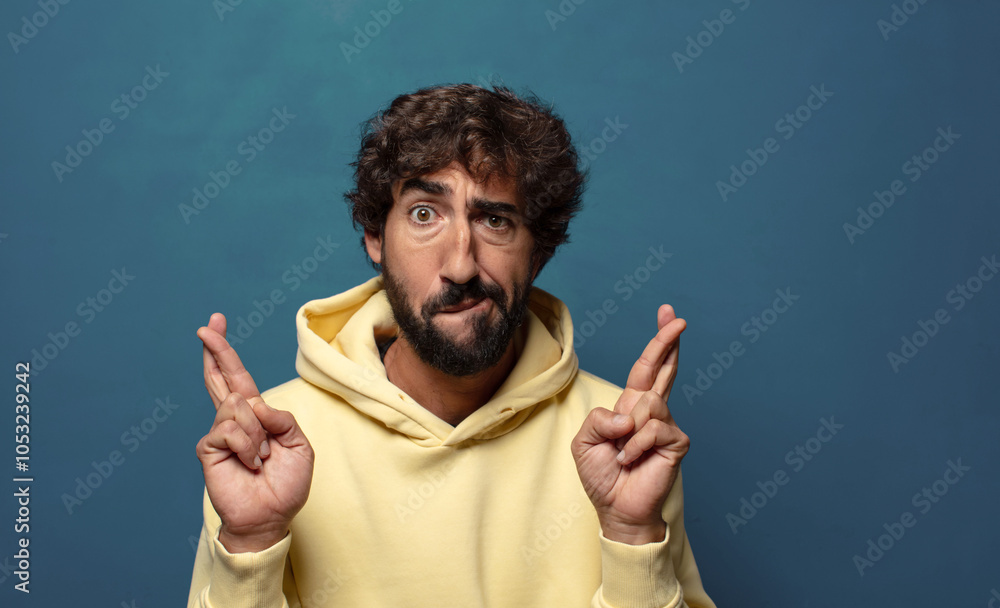 crossing fingers anxiously and hoping for good luck with a worried look crossing fingers anxiously and hoping for good luck with a worried look