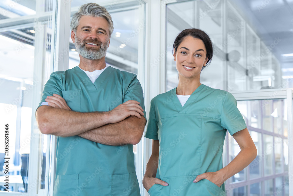 Fototapeta premium Two doctors standing in the clinic corridor and looking confident