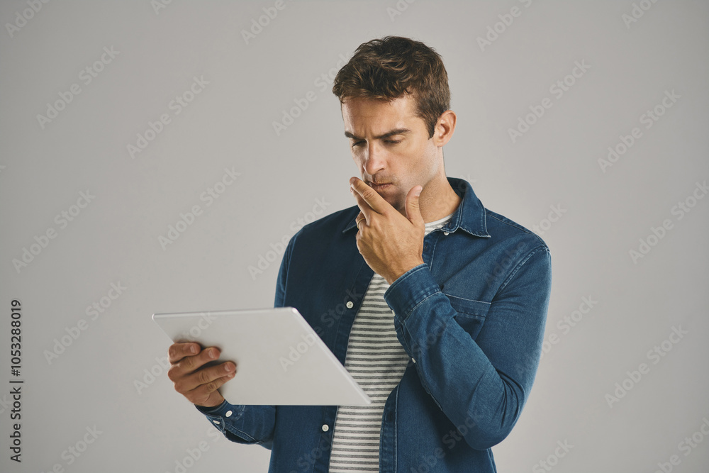 Search, tablet and thinking with man in studio isolated on gray background for app download or update. Idea, planning and problem solving with confused user in casual outfit for online shopping Search, tablet and thinking with man in studio isolated on gray background for app download or update. Idea, planning and problem solving with confused user in casual outfit for online shopping