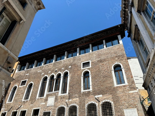 Bild auf Leinwand A view from below of the austere medieval Gothic style Palazzo Selvadego in Venice under the bright summer sun