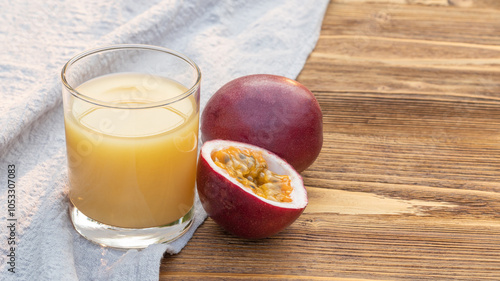 Fresh passion fruit juice on a wooden table. photo