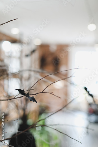 Happy Halloween concept. White fake white wool spiderweb. Scary spiders, candles, bats. Interior of festive living room with scary Halloween decorations