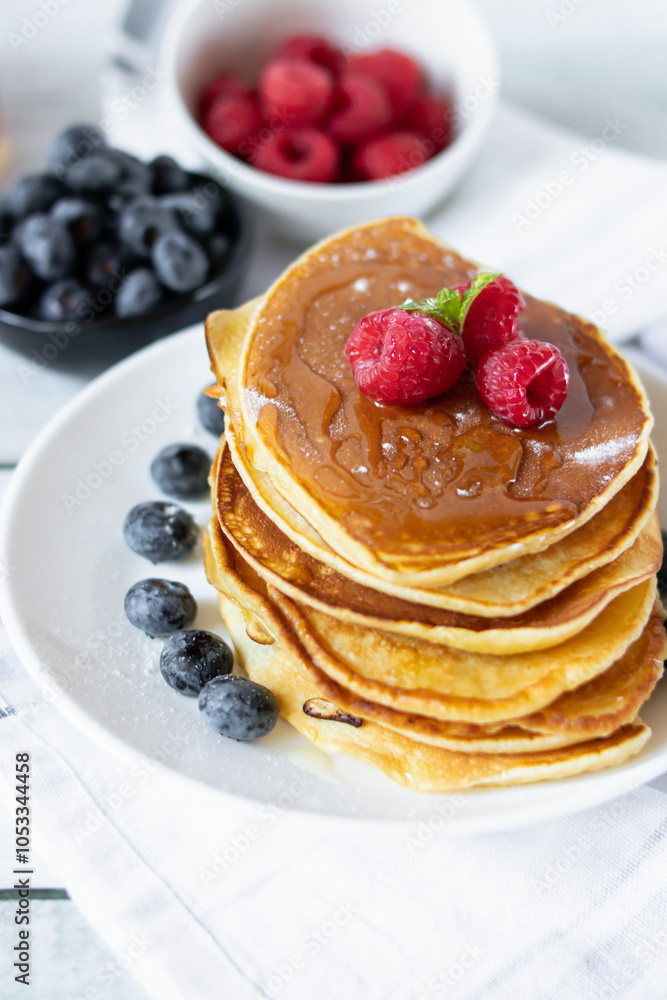 Pancakes with fresh berries and honey. on a wooden background. breakfast Pancakes with fresh berries and honey. on a wooden background. breakfast