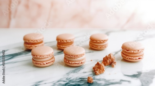 A row of perfectly shaped macarons on a marble countertop perfectionism photo