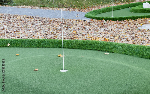 Mini golf course, close-up. Green artificial grass on miniature golf course photo