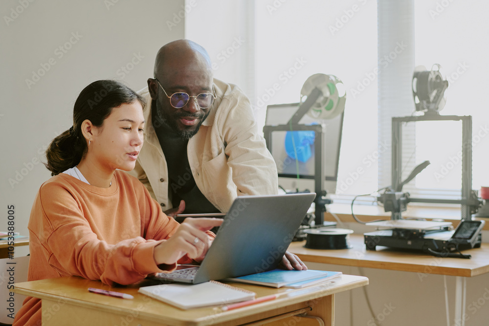 Hispanic woman working with African American man on laptop in well-lit modern office equipped with 3D printer and model replicating space, showing professional engagement Hispanic woman working with African American man on laptop in well-lit modern office equipped with 3D printer and model replicating space, showing professional engagement