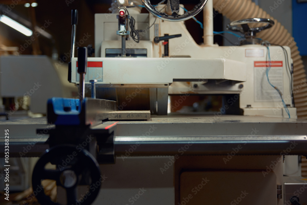 Fototapeta premium Thickness planer machine to trim wood plank closeup view, woodworking workshop