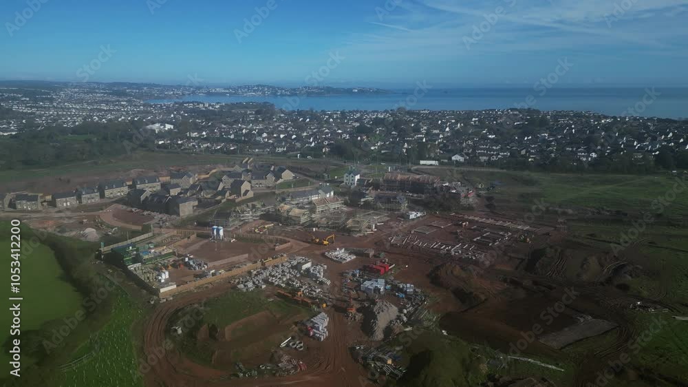Paignton, South Devon, England: DRONE VIEWS: The second phase of a new build housing development called Inglewood under construction. Paignton is a popular UK holiday resort (Clip 1). Paignton, South Devon, England: DRONE VIEWS: The second phase of a new build housing development called Inglewood under construction. Paignton is a popular UK holiday resort (Clip 1).