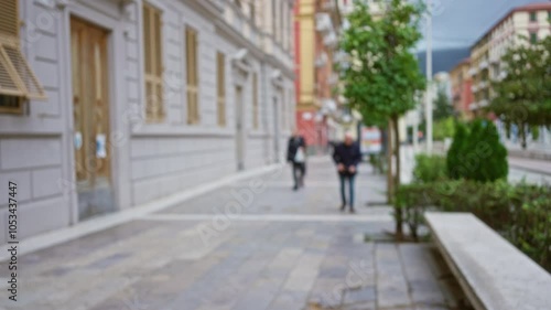 Wallpaper Mural Blurred street scene in la spezia, italy with people walking along a defocused urban street surrounded by classic buildings and trees. Torontodigital.ca