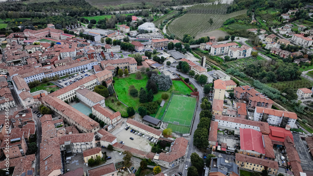 Obraz premium Aerial view of Alba Italy highlighting historic buildings and green spaces in the town