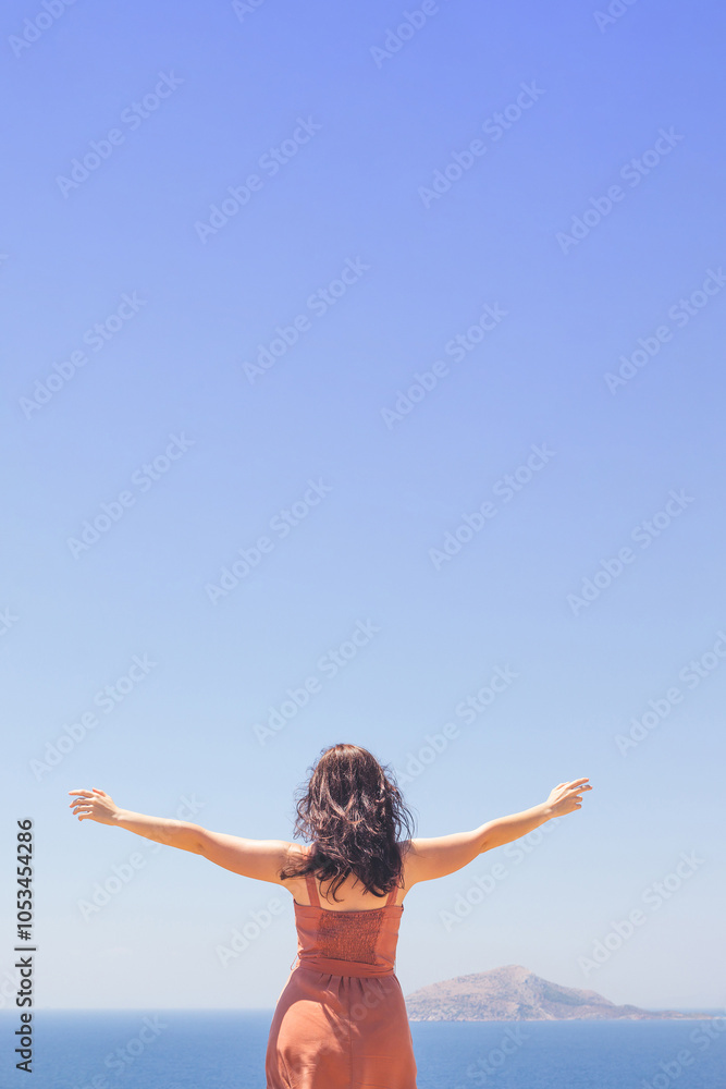 Young girl in dress looking at blue seascape and enjoying summer vacation Young girl in dress looking at blue seascape and enjoying summer vacation