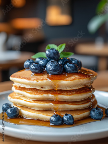 Stack of pancakes with blueberries and syrup. photo