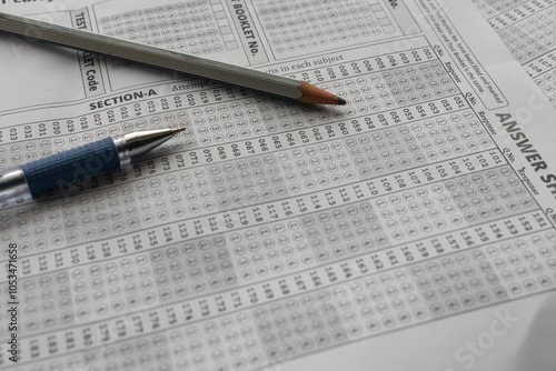Blank OMR sheet with pencil pen NEET, JEE, exam centre hall student teacher time important leak paper question marks marking tick scam cheating AIR rank coaching course