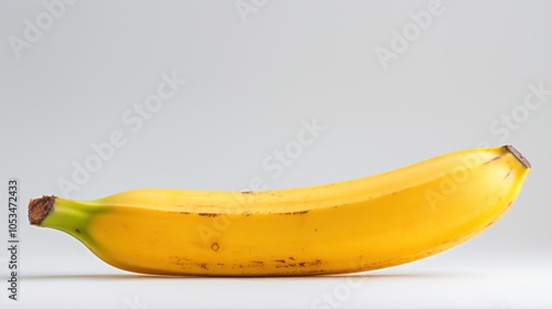 a perfectly ripe banana, with its smooth yellow skin and slight brown speckles,