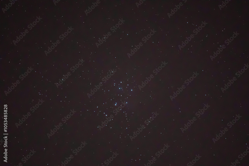 Fototapeta premium Night details with the sky full of stars observed from an wild place on Earth. The universe illuminated by infinite brilliance. Pleiades and Taurus constellation covered with artificial sattelites