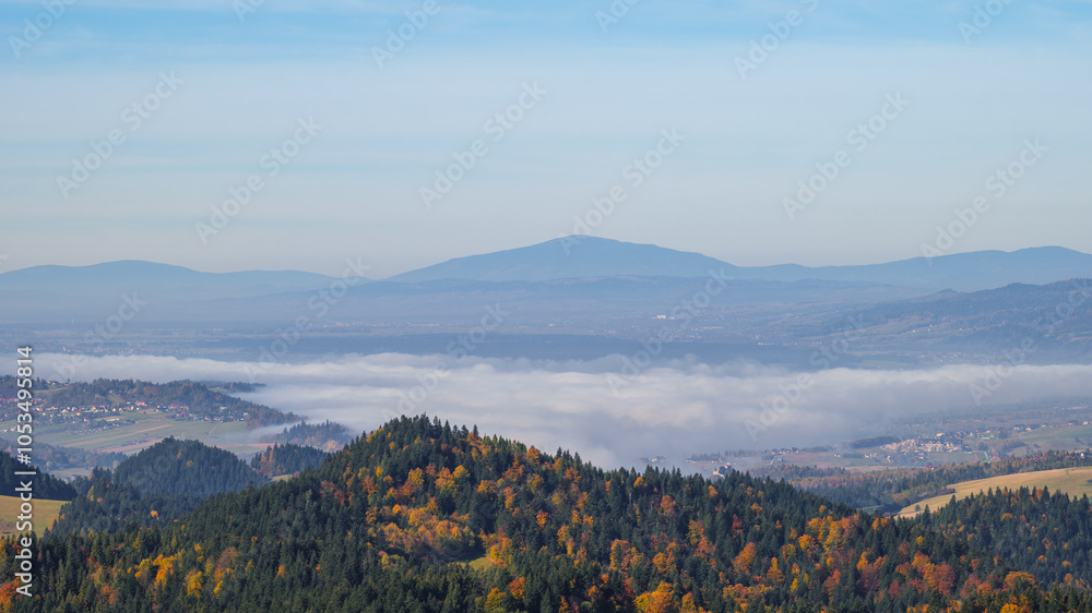 A lonely mountain in the distance. Babia Góra. View from the top of Trzy Korony. Clouds in the valley. Autumn, Pieniny Mountains, Poland