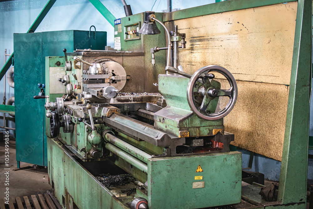 A lathe operating in a factory workshop during machinery manufacturing, focusing on precision engineering tasks and metal processing activities A lathe operating in a factory workshop during machinery manufacturing, focusing on precision engineering tasks and metal processing activities