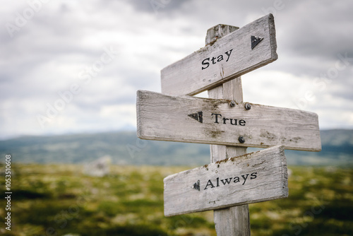 Billede på lærred stay true always text quote written on wooden signpost at the crossroads outdoors in nature