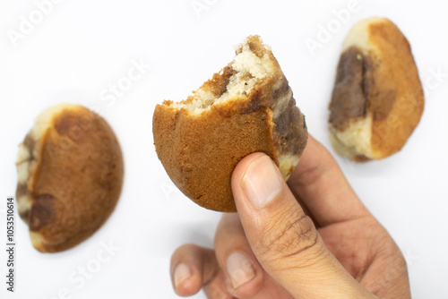 the hand that is holding the Banyumas pukis cake photo