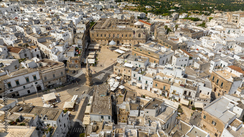 Aerial view of the church of San Francesco, the column of Sant' Oronzo and the town hall of Ostuni, in the province of Brindisi, in Puglia, Italy. They are located in the historic center of the city.
