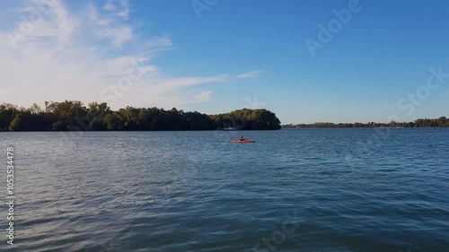 Man in Kayak paddling on calm Danube river in Belgrade, Serbia on sunny day. photo