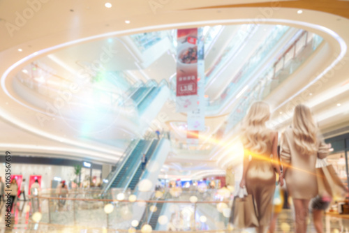 Shenzhen shopping mall interior with escalators, people shopping, and bright lights.