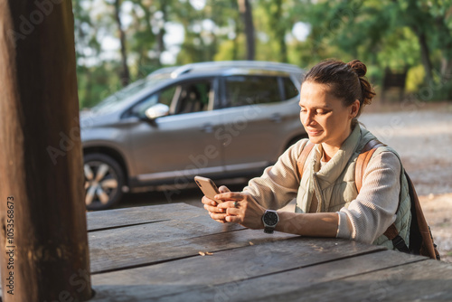 Obraz na płótnie Female driver traveler sitting in rest area for drivers with phone in hands w salonie