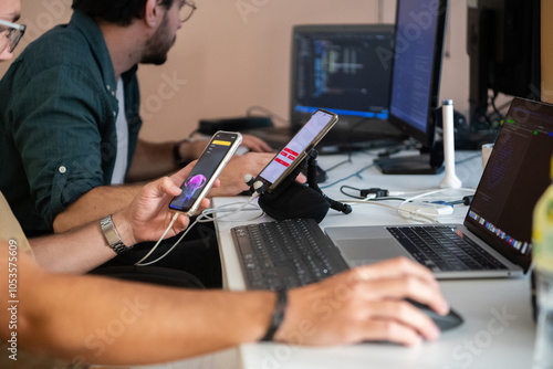 Programmers engrossed in deep collaboration, diligently working together to solve complex problems and develop innovative mobile applications with seamless functionality.