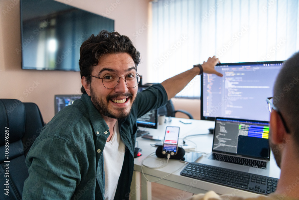Fototapeta premium Programmers engrossed in deep collaboration, diligently working together to solve complex problems and develop innovative mobile applications with seamless functionality.