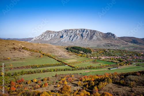 Piatra Secuiului - Scenic Autumn Landscape with Mountain, Village, and Fields in Transylvania, Romania photo