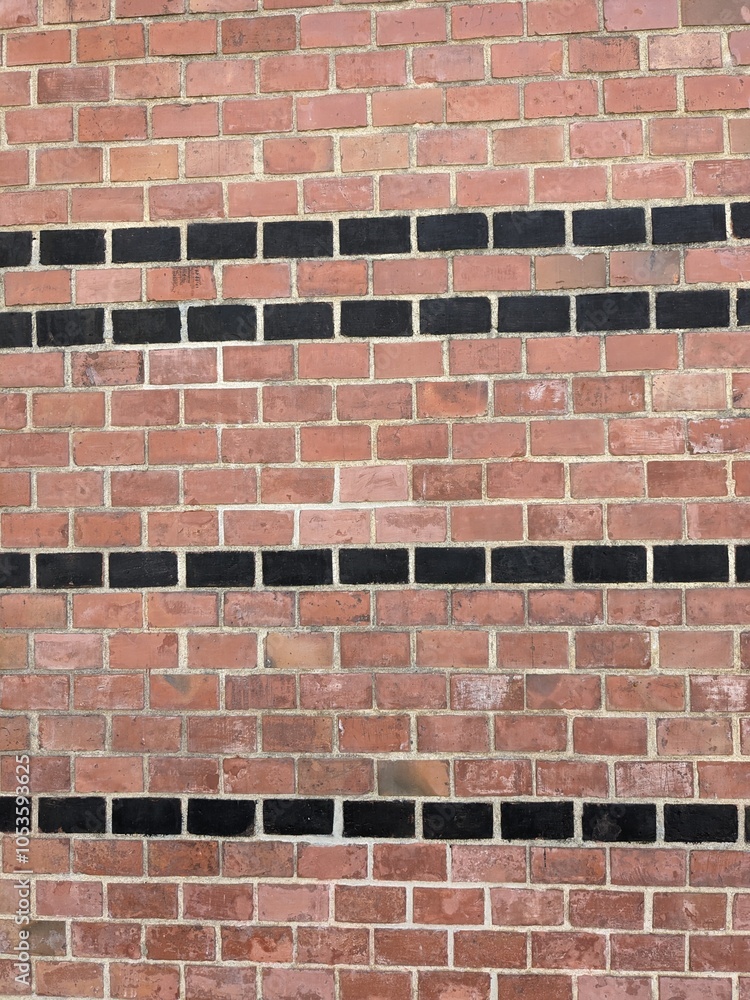 Obraz premium Architectural brickwork with alternating red and black bricks in a strip pattern typical of first republic era buildings.