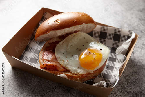 Egg and bacon roll in cardboard tray photo