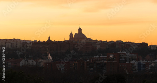 view of the city of madrid at dawn with the rays of the sun, cathedral of madrid