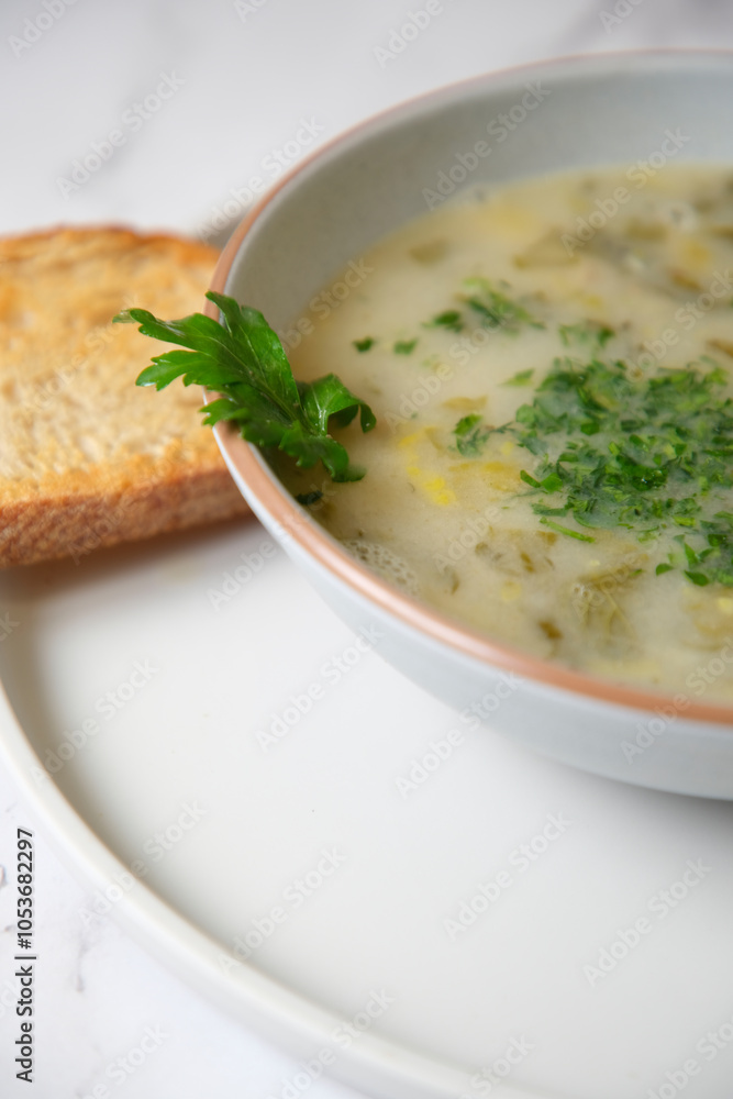Cream of mushroom soup with a slice of toasted bread. Cream of mushroom soup with a slice of toasted bread.
