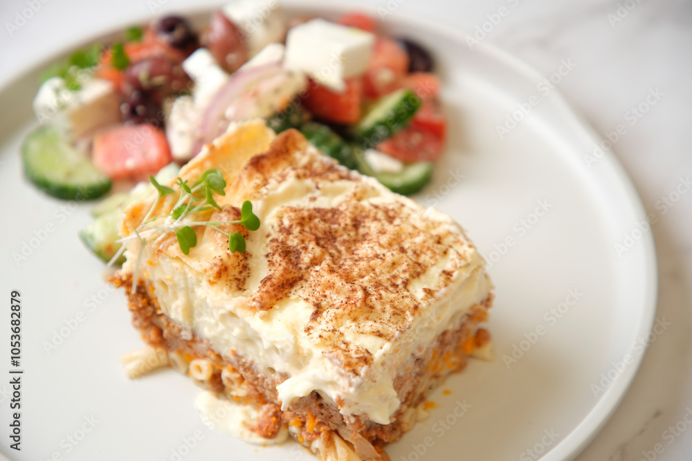 a slice of baked dish with fresh vegetable salad on the side a slice of baked dish with fresh vegetable salad on the side