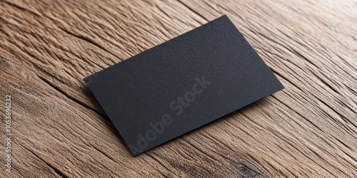 Blank black business card on rustic wooden background. photo