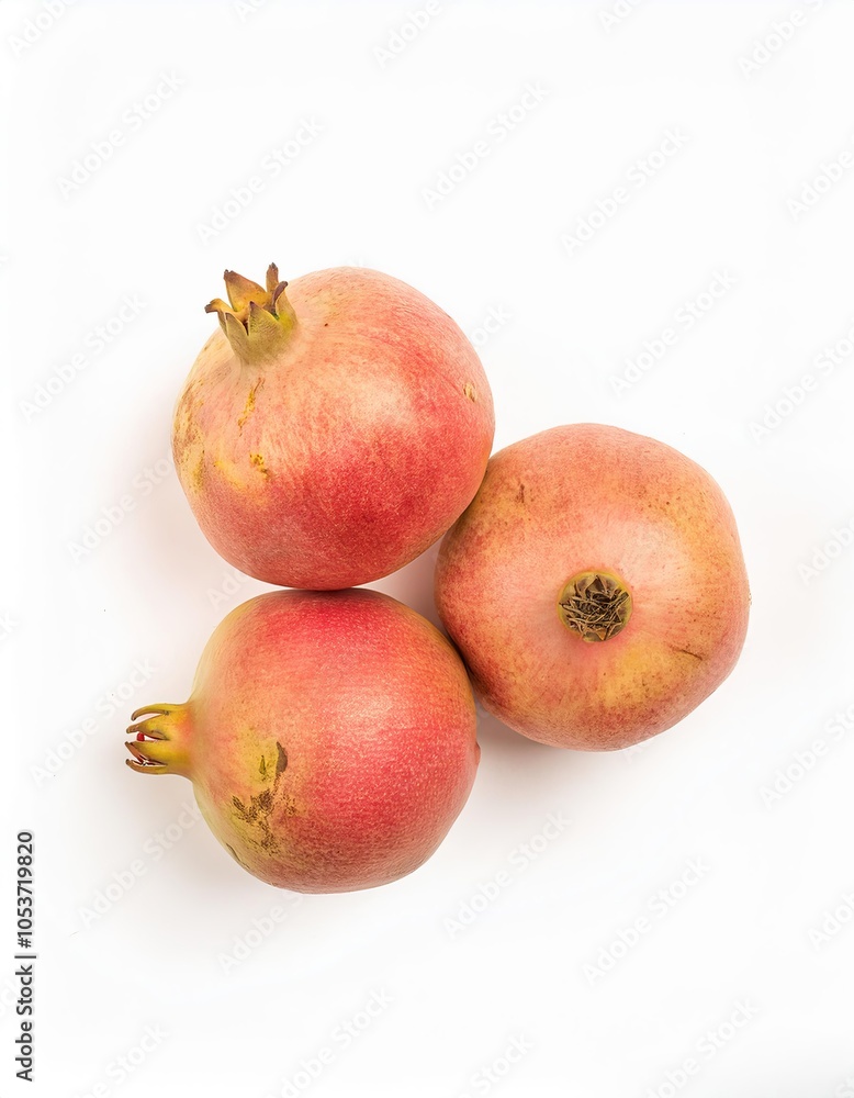 Three pomegranates resting on a white background Three pomegranates resting on a white background